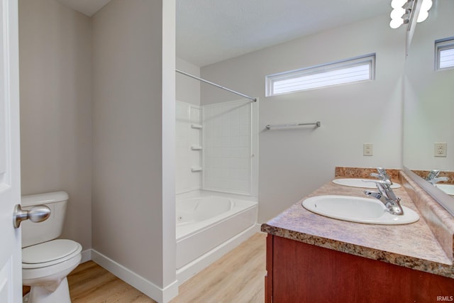 bathroom featuring wood finished floors, a sink, and toilet