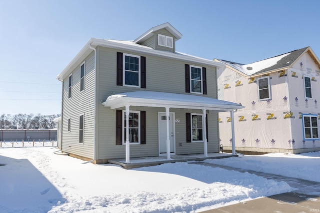 view of front of home with covered porch and fence