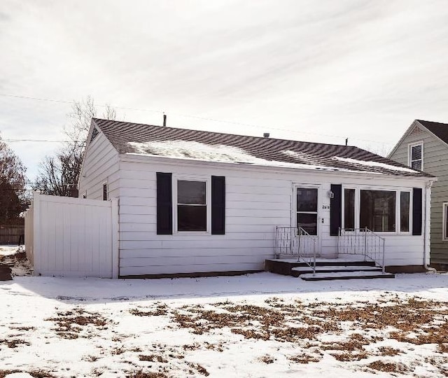 exterior space featuring a shingled roof