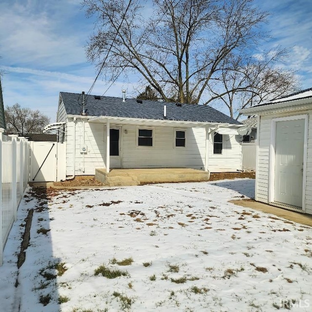 snow covered property featuring fence