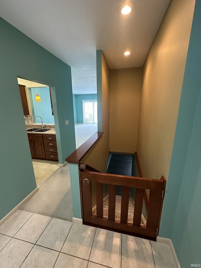 staircase featuring baseboards and recessed lighting