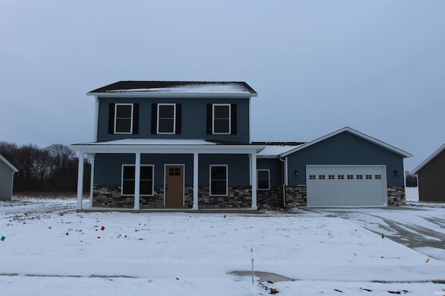 view of front of home with stone siding, covered porch, and an attached garage