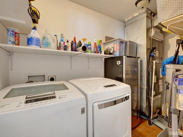 washroom featuring tile patterned flooring, laundry area, and separate washer and dryer