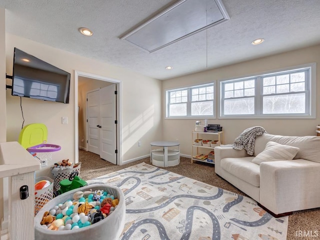 interior space with attic access, baseboards, a textured ceiling, carpet flooring, and recessed lighting