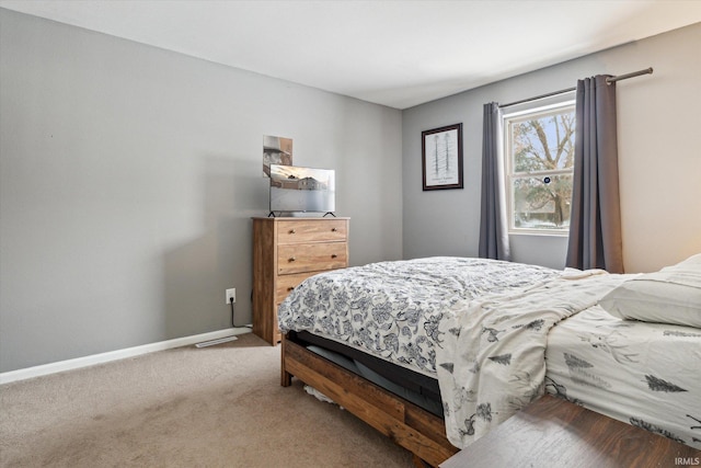 bedroom featuring carpet flooring and baseboards