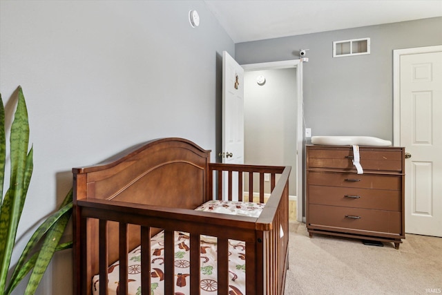 bedroom featuring light carpet and visible vents