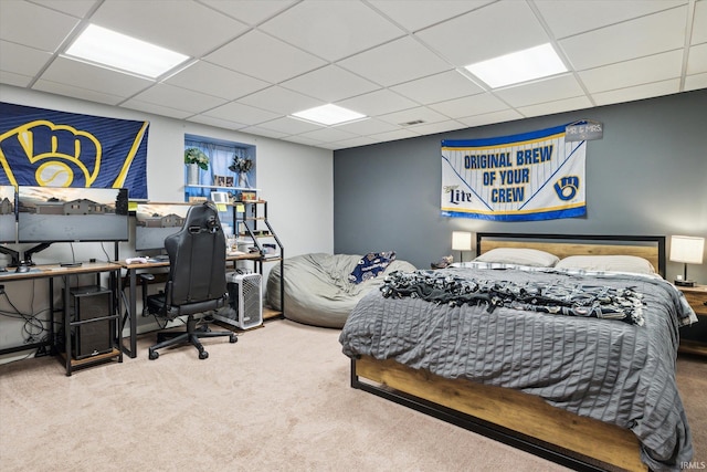 bedroom featuring a drop ceiling and carpet flooring