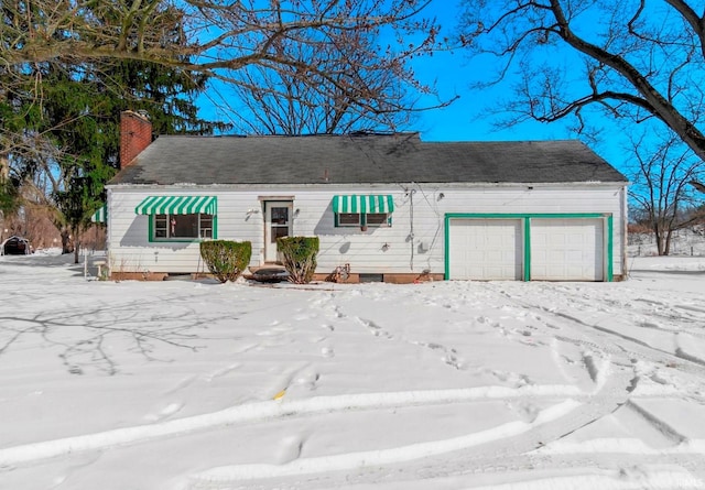 view of front of home with a garage and a chimney