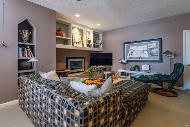 carpeted living area featuring recessed lighting, a fireplace, a textured ceiling, and baseboards