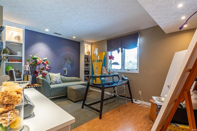 living area with carpet, visible vents, a textured ceiling, and baseboards