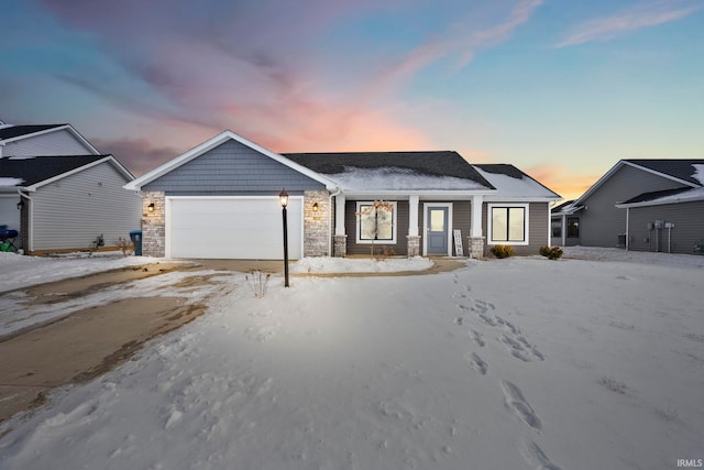 single story home with a garage, stone siding, and driveway