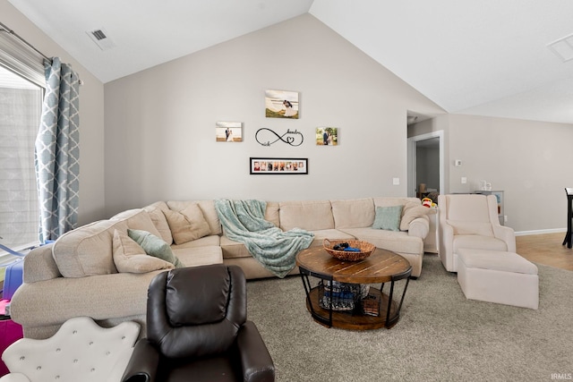 living area with vaulted ceiling, visible vents, and baseboards