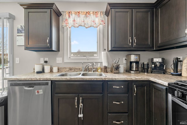 kitchen with stainless steel appliances, light countertops, a sink, and dark brown cabinetry