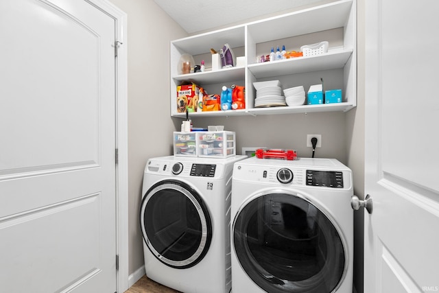 washroom featuring washer and dryer and laundry area