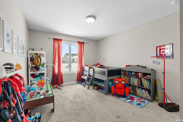 playroom featuring carpet floors, a textured ceiling, and baseboards