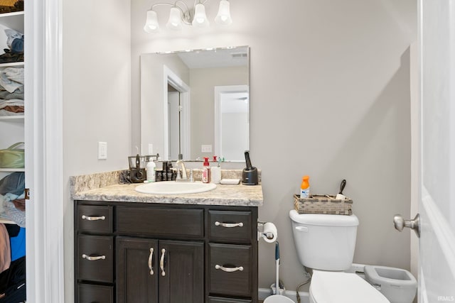 bathroom with toilet and vanity