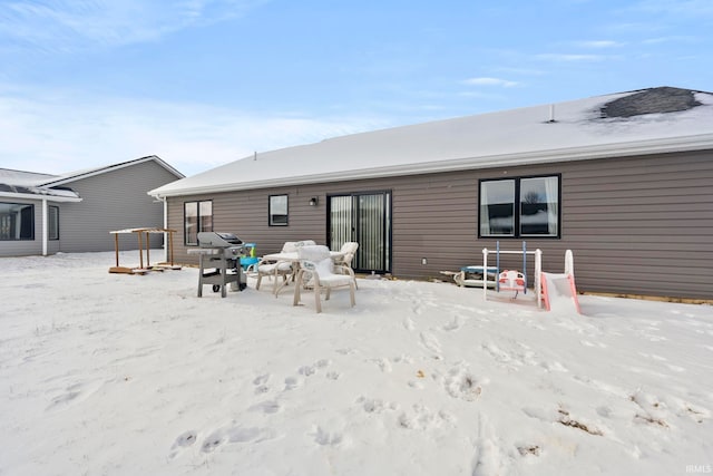 view of snow covered rear of property