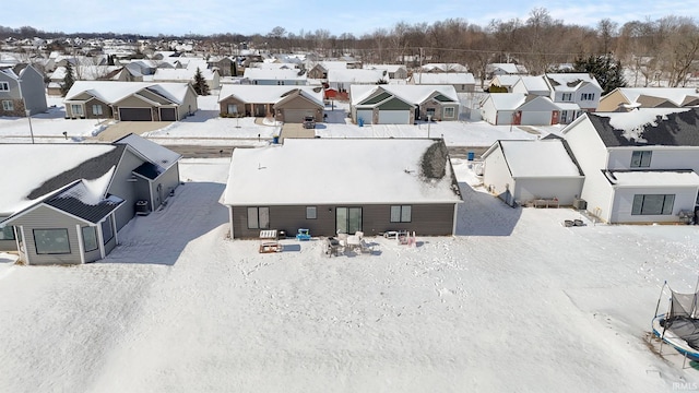 snowy aerial view featuring a residential view