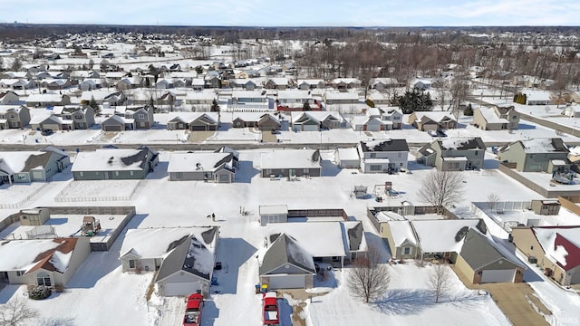 snowy aerial view with a residential view