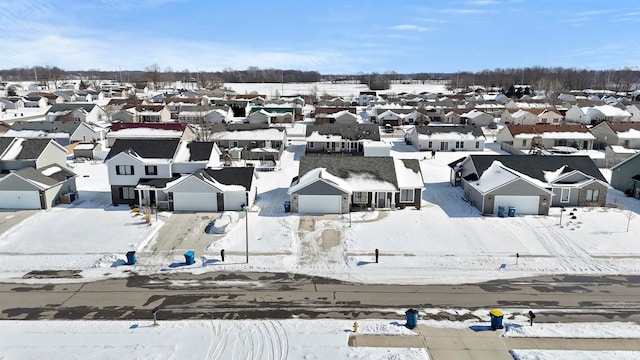 snowy aerial view with a residential view