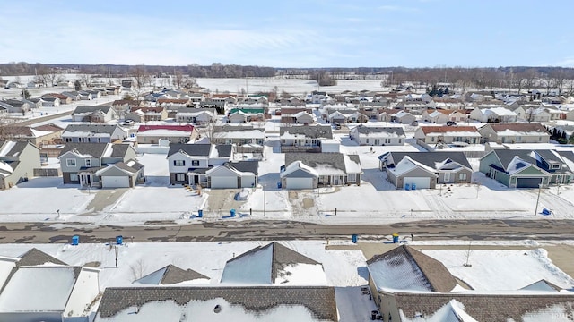 snowy aerial view with a residential view