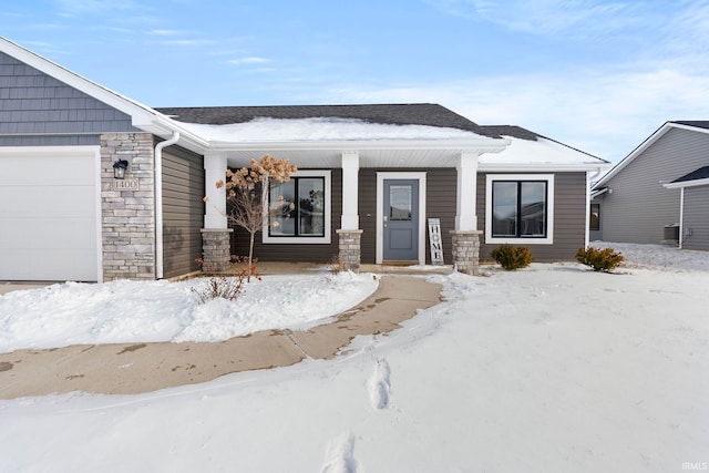 view of front of house featuring a garage and stone siding