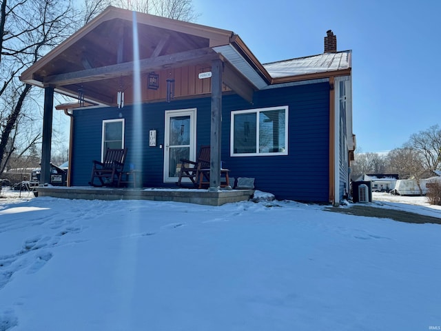 view of front of property with covered porch and a chimney