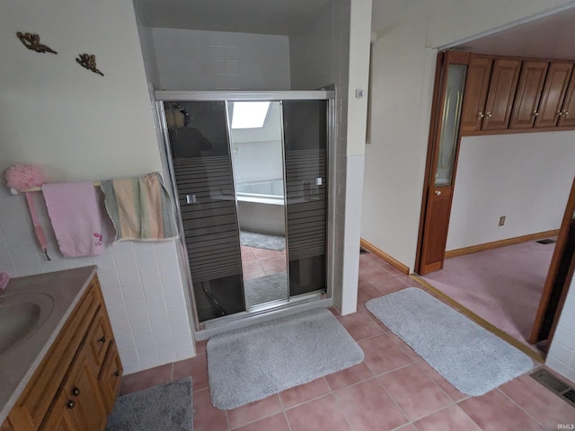 bathroom with tile patterned flooring, visible vents, vanity, and a shower stall