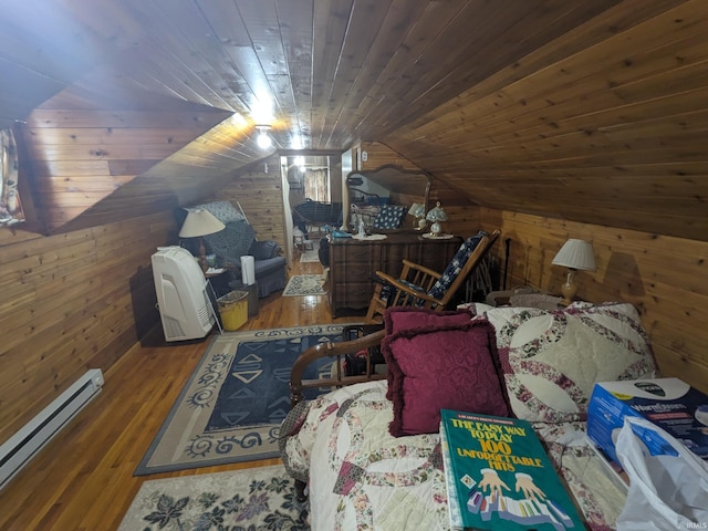 bedroom featuring wooden ceiling, wood walls, baseboard heating, and wood finished floors