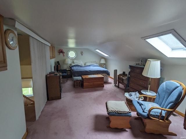 bedroom with lofted ceiling with skylight, baseboards, and light colored carpet