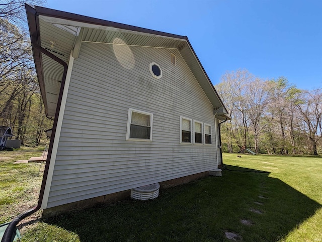 view of home's exterior with a yard