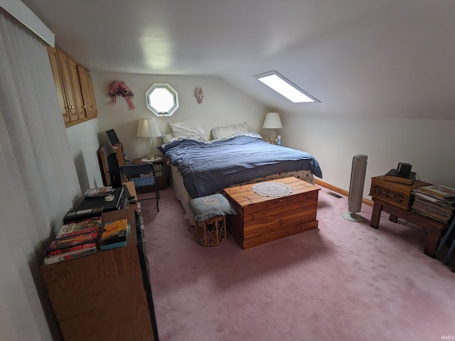 bedroom featuring vaulted ceiling with skylight and carpet flooring