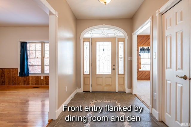 foyer entrance featuring wood walls and wood finished floors