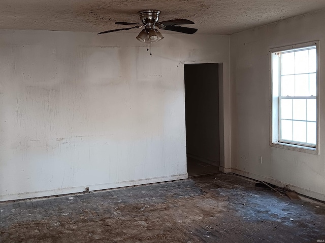 unfurnished room featuring a ceiling fan and a textured ceiling