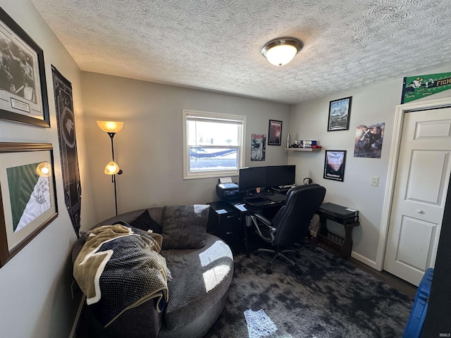 office area with a textured ceiling and baseboards