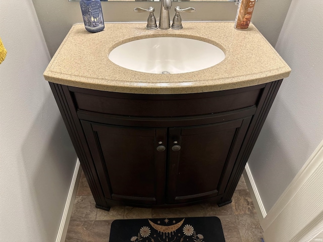 interior details featuring baseboards and a sink