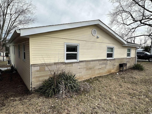 view of side of home featuring a yard