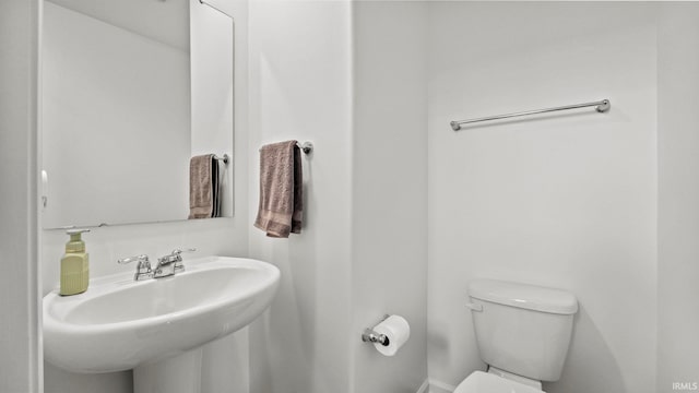 bathroom with toilet and a sink