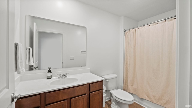 bathroom featuring toilet, shower / bath combo, and vanity