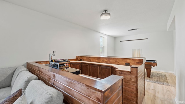 kitchen with open floor plan, light wood-style flooring, and baseboards