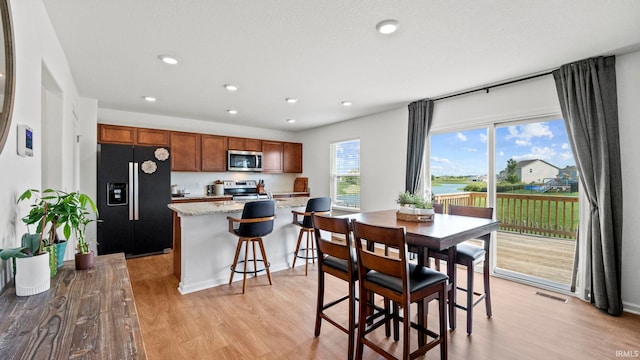 dining space featuring recessed lighting, visible vents, and light wood-style floors