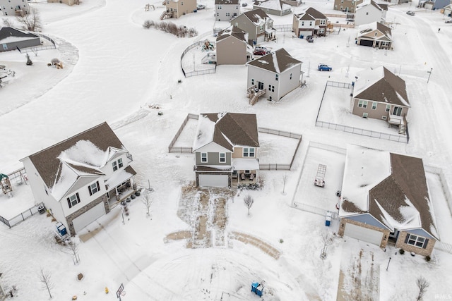 snowy aerial view featuring a residential view