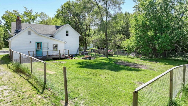 view of yard with a fenced backyard and a wooden deck