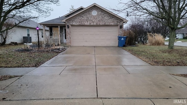 ranch-style house with a garage, brick siding, driveway, and central air condition unit