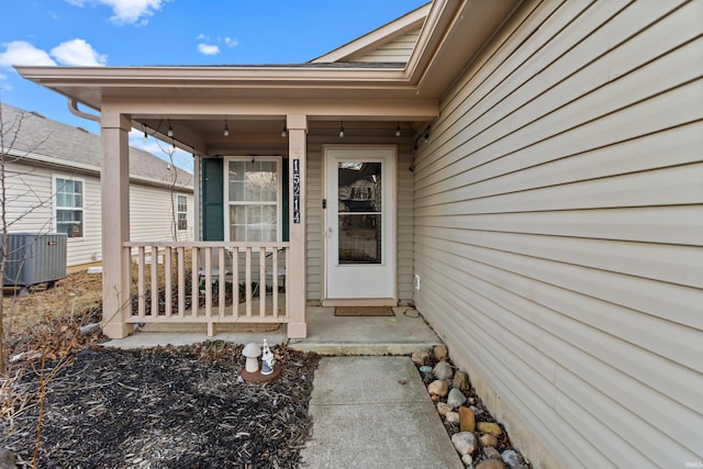 property entrance featuring a porch and central air condition unit