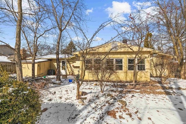 snow covered property featuring cooling unit