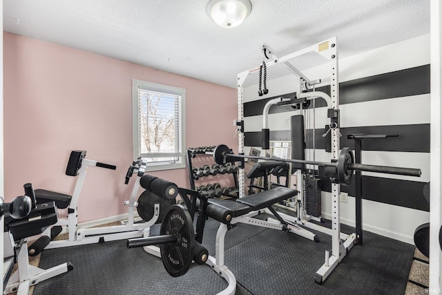 workout area with baseboards and a textured ceiling