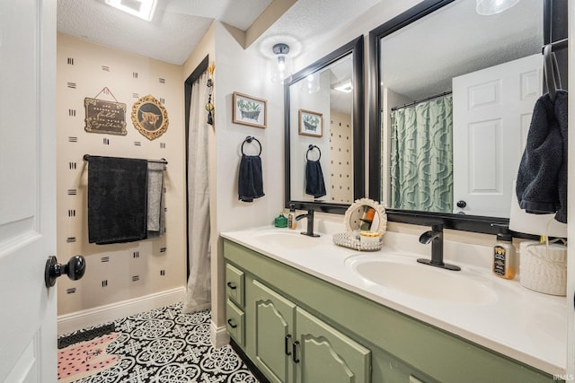 bathroom featuring double vanity, tile patterned flooring, a textured ceiling, and a sink