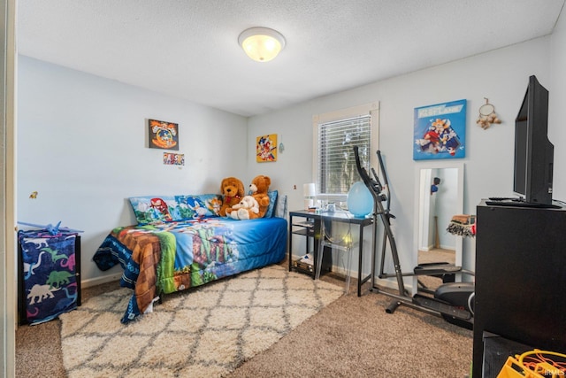 bedroom with a textured ceiling, carpet, and baseboards