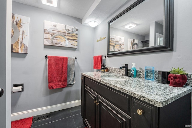 bathroom with tile patterned flooring, visible vents, vanity, and baseboards